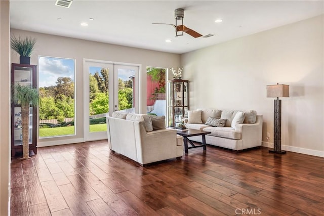 living room featuring recessed lighting, dark wood-style flooring, visible vents, and ceiling fan