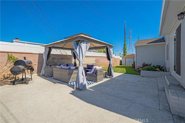view of patio / terrace featuring a storage shed, outdoor lounge area, area for grilling, a fenced backyard, and an outbuilding