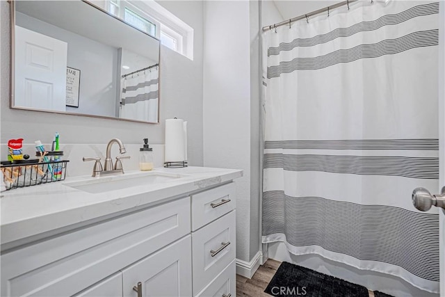 full bath with a shower with shower curtain, vanity, and wood finished floors