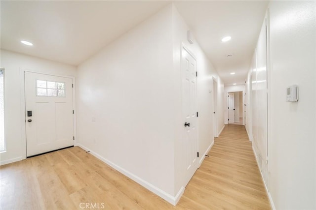foyer entrance featuring light wood-style flooring, baseboards, and recessed lighting