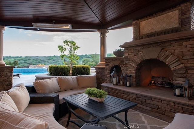 view of patio featuring a gazebo, an outdoor living space with a fireplace, and an outdoor pool