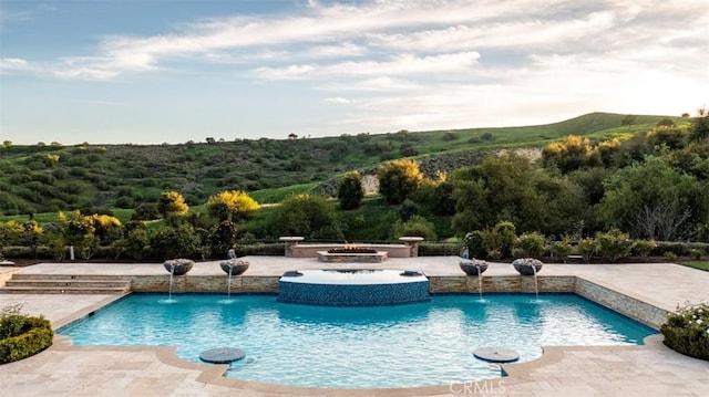 outdoor pool with a patio area