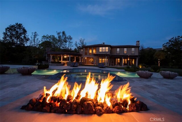 view of pool with an outdoor fire pit, a patio, and a pool with connected hot tub