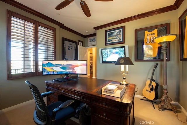 carpeted home office with baseboards, a ceiling fan, crown molding, and plenty of natural light