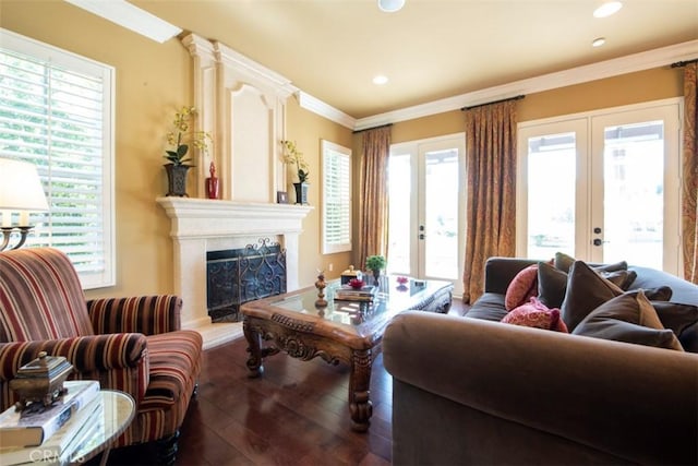 living area featuring french doors, a healthy amount of sunlight, a high end fireplace, and wood-type flooring
