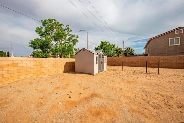 39356 Nicole Dr, Palmdale, CA 93551 - view of yard with an outbuilding, a storage unit, and a fenced backyard