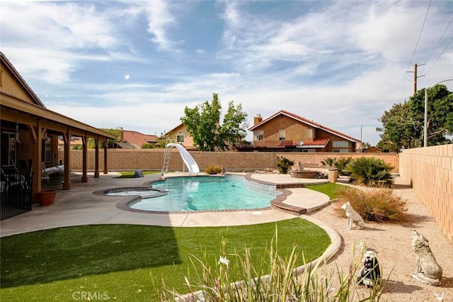 39356 Nicole Dr, Palmdale, CA 93551 - view of pool with a yard, a water slide, a patio area, a fenced backyard, and a pool with connected hot tub