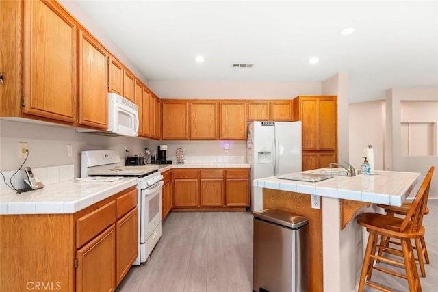 39356 Nicole Dr, Palmdale, CA 93551 - kitchen featuring recessed lighting, white appliances, visible vents, and light wood finished floors