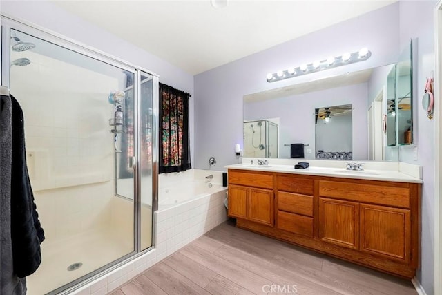 39356 Nicole Dr, Palmdale, CA 93551 - full bathroom featuring a bath, a sink, double vanity, wood finished floors, and a stall shower