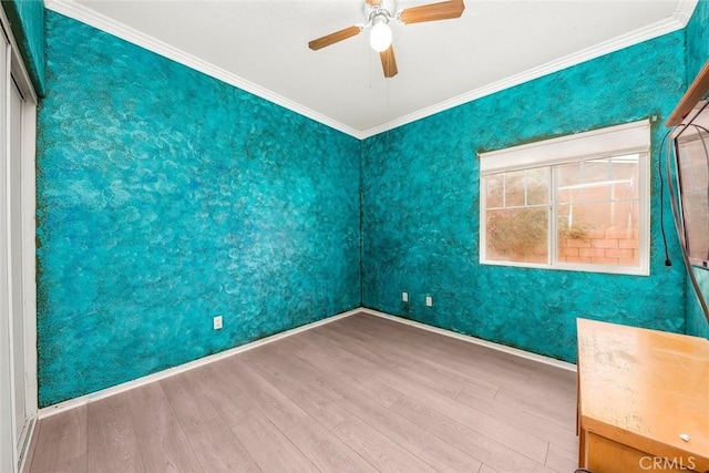 39356 Nicole Dr, Palmdale, CA 93551 - spare room featuring crown molding, wood finished floors, ceiling fan, and baseboards
