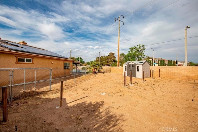 39356 Nicole Dr, Palmdale, CA 93551 - view of yard featuring a storage shed, a fenced backyard, and an outdoor structure