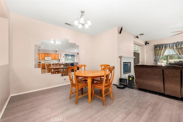 39356 Nicole Dr, Palmdale, CA 93551 - dining room with a chandelier, light wood finished floors, baseboards, and visible vents