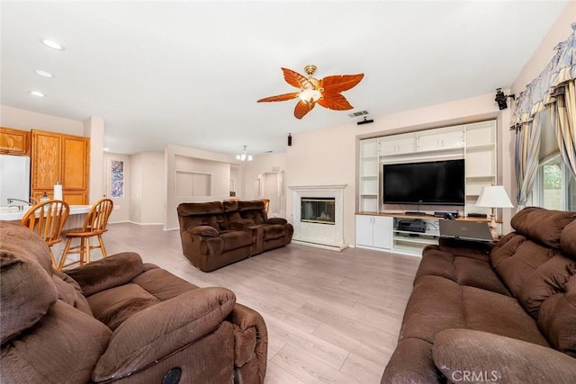 39356 Nicole Dr, Palmdale, CA 93551 - living room featuring light wood-type flooring, ceiling fan, visible vents, and recessed lighting