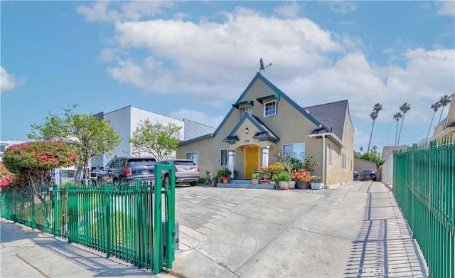 236 N Catalina St, Los Angeles, CA 90004 - view of front of house featuring roof with shingles, stucco siding, driveway, and a fenced front yard