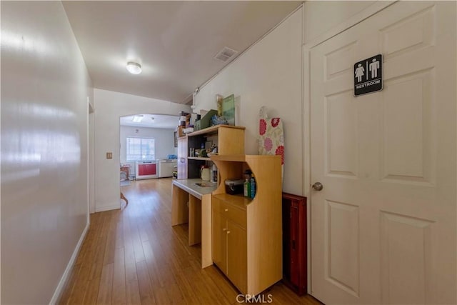 236 N Catalina St, Los Angeles, CA 90004 - corridor with visible vents, baseboards, light wood finished floors, and arched walkways