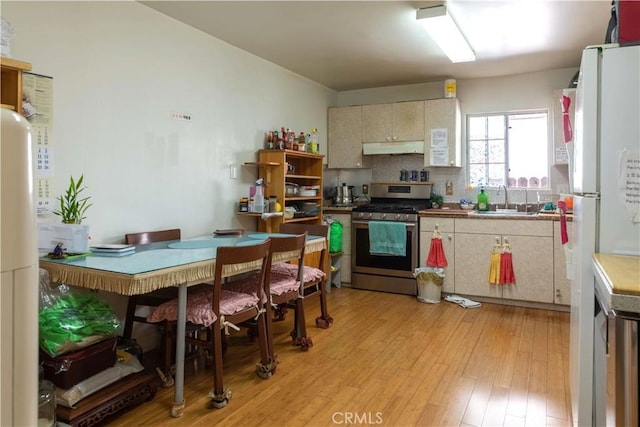 236 N Catalina St, Los Angeles, CA 90004 - kitchen with gas stove, freestanding refrigerator, under cabinet range hood, light wood-style floors, and a sink