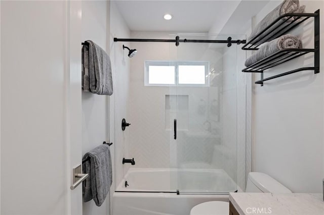 full bath featuring toilet, vanity, and combined bath / shower with glass door