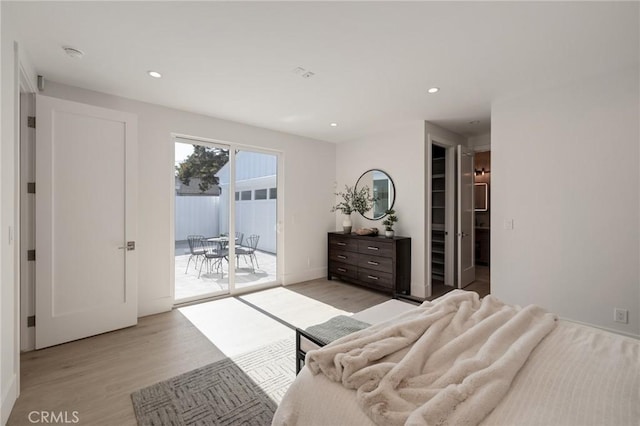 bedroom with light wood-type flooring, baseboards, recessed lighting, and access to exterior