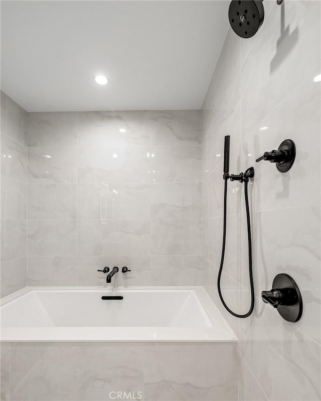 bathroom with a bathing tub and tiled shower