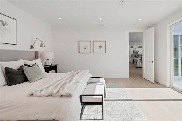 bedroom with recessed lighting, light wood-type flooring, and baseboards