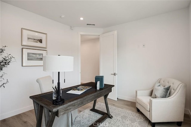 office area with recessed lighting, light wood-style floors, visible vents, and baseboards