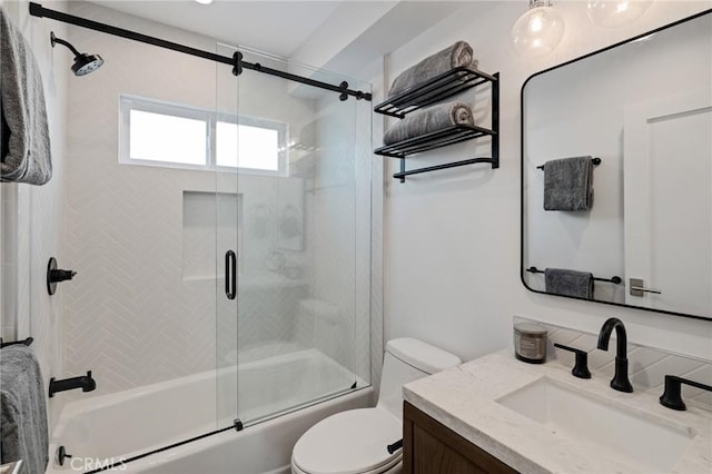 bathroom with vanity, bath / shower combo with glass door, and toilet