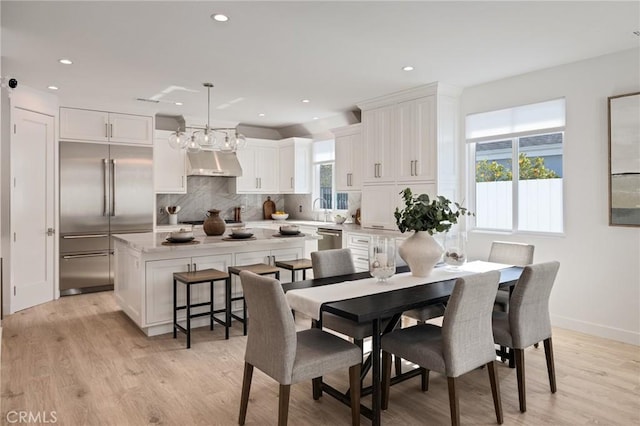 dining room featuring light wood-type flooring, baseboards, and recessed lighting