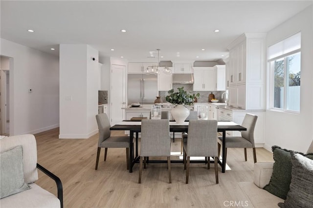 dining room featuring baseboards, recessed lighting, and light wood-type flooring