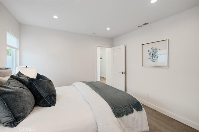 bedroom with wood finished floors, visible vents, and recessed lighting