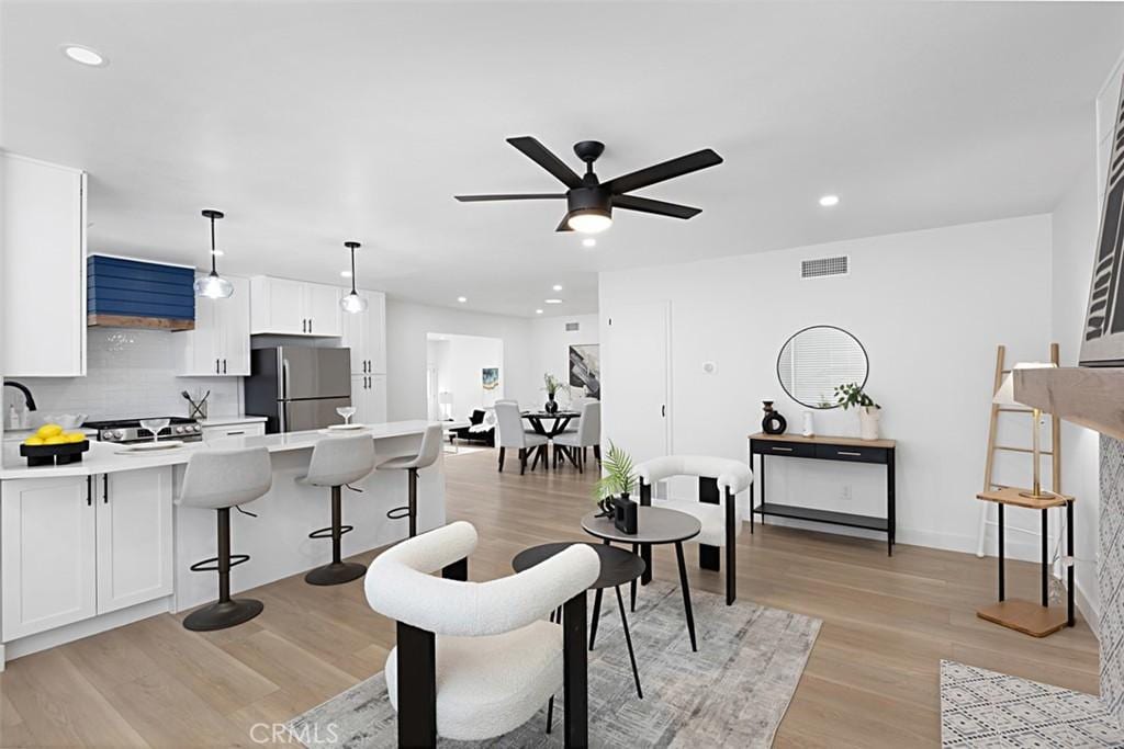 3988 Ashford St, San Diego, CA 92111 - living area featuring ceiling fan, visible vents, light wood-type flooring, baseboards, and recessed lighting