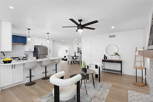 3988 Ashford St, San Diego, CA 92111 - living area featuring ceiling fan, visible vents, light wood-type flooring, baseboards, and recessed lighting
