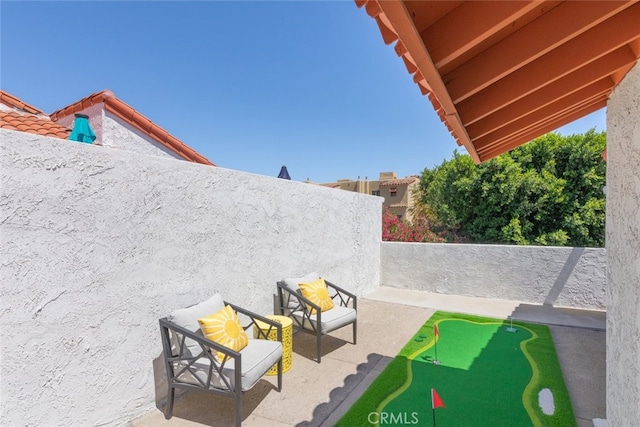 280 S Avenida Caballeros Unit 271, Palm Springs, CA 92262 - fenced backyard featuring a putting area and a patio