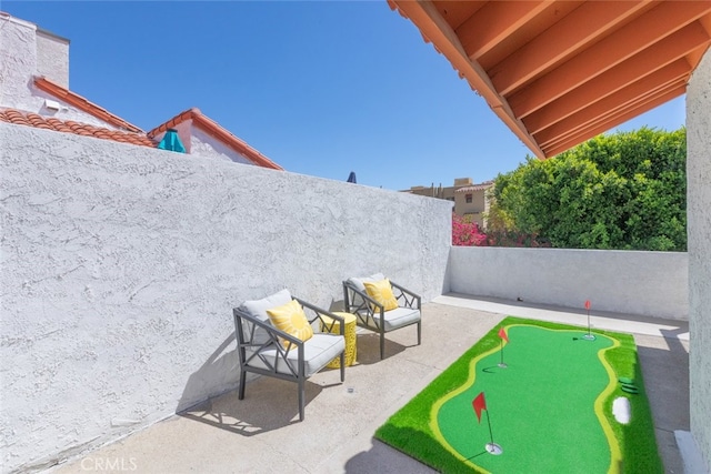 280 S Avenida Caballeros Unit 271, Palm Springs, CA 92262 - fenced backyard with an area to practice putting and a patio area