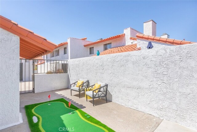 280 S Avenida Caballeros Unit 271, Palm Springs, CA 92262 - view of patio / terrace with a putting area