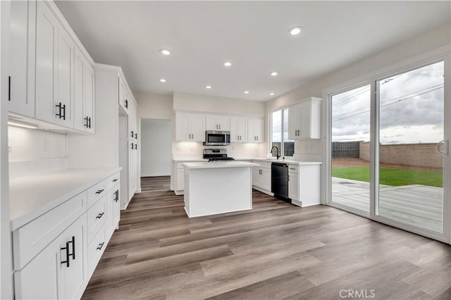 29605 Camino Cristal, Menifee, CA 92584 - kitchen with recessed lighting, light countertops, a kitchen island, appliances with stainless steel finishes, and white cabinetry