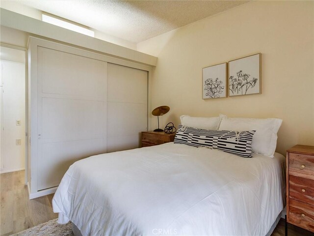 13061 Oak Hill Dr Unit 221B, Seal Beach, CA 90740 - bedroom with a closet and wood finished floors