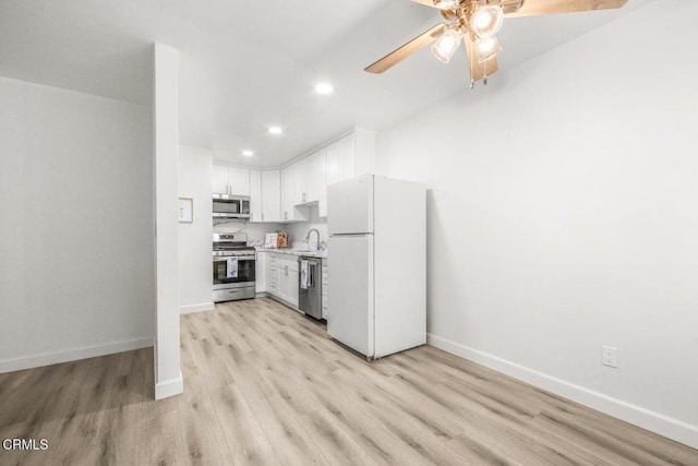 138 S Bryn Mawr St Unit 27, Ventura, CA 93003 - kitchen with stainless steel appliances, light wood-style flooring, a ceiling fan, recessed lighting, and white cabinetry