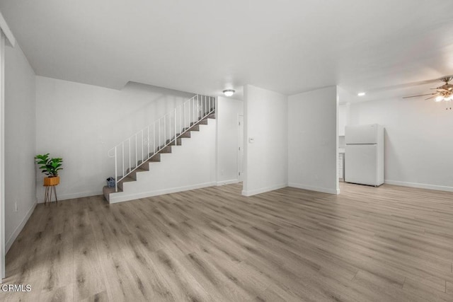 138 S Bryn Mawr St Unit 27, Ventura, CA 93003 - unfurnished living room featuring stairway, light wood-style flooring, and a ceiling fan
