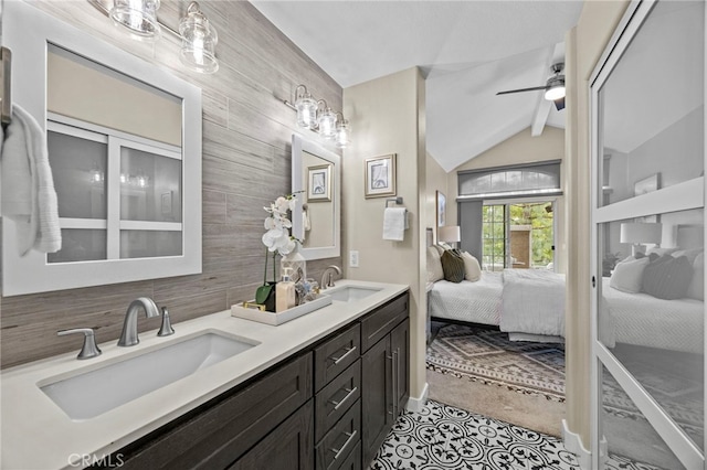 ensuite bathroom with vaulted ceiling, ensuite bath, a sink, and backsplash
