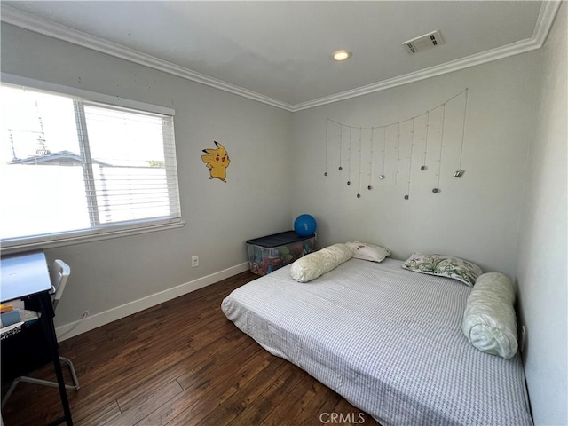 bedroom with wood-type flooring, baseboards, visible vents, and ornamental molding