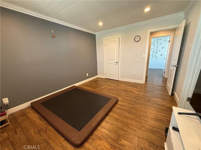 unfurnished bedroom with crown molding, recessed lighting, baseboards, and wood-type flooring