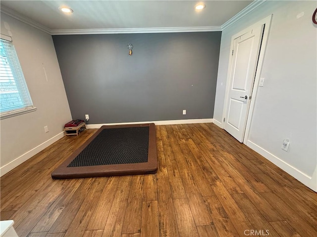 empty room featuring recessed lighting, baseboards, ornamental molding, and hardwood / wood-style flooring