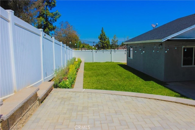 view of yard with a patio and a fenced backyard