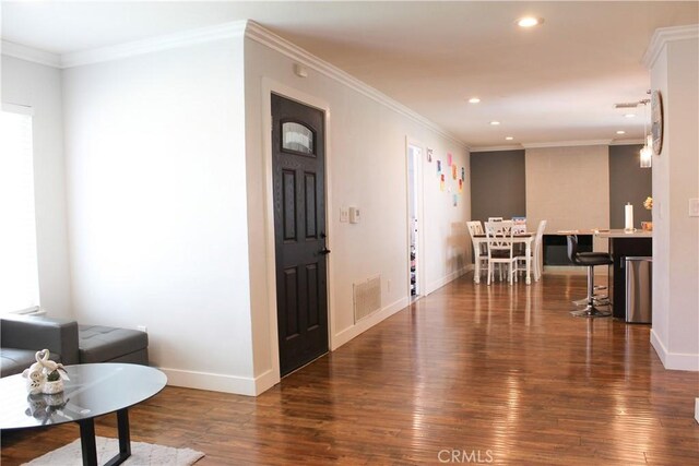 interior space featuring visible vents, crown molding, wood finished floors, baseboards, and recessed lighting