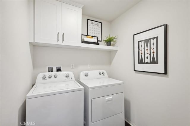laundry room with cabinet space and washing machine and dryer