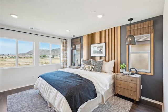 bedroom with visible vents, recessed lighting, dark wood-style flooring, a mountain view, and baseboards