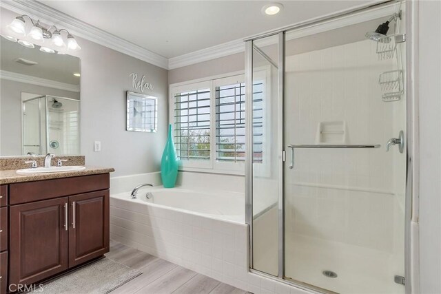 17963 Passionflower Ln, San Bernardino, CA 92407 - bathroom featuring a stall shower, wood finished floors, vanity, a bath, and crown molding