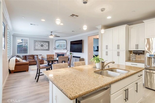17963 Passionflower Ln, San Bernardino, CA 92407 - kitchen featuring a sink, appliances with stainless steel finishes, ornamental molding, open floor plan, and a ceiling fan