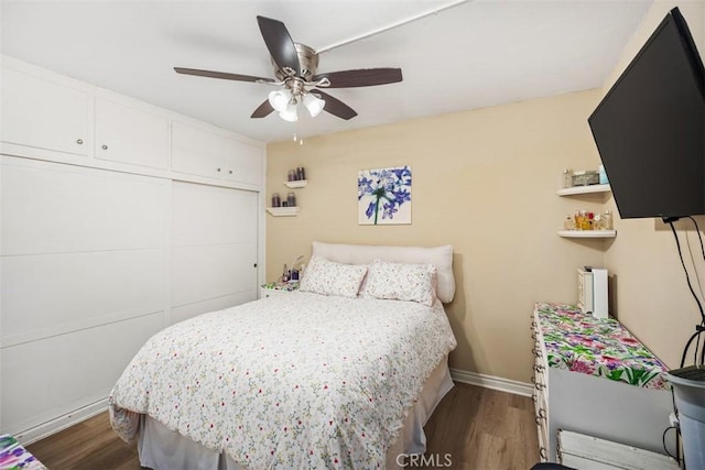 321 Avenida Carmel Unit H, Laguna Woods, CA 92637 - bedroom with a ceiling fan, baseboards, and dark wood-style flooring