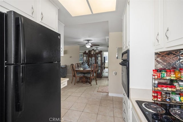 321 Avenida Carmel Unit H, Laguna Woods, CA 92637 - kitchen featuring a ceiling fan, black appliances, light tile patterned floors, light countertops, and white cabinetry
